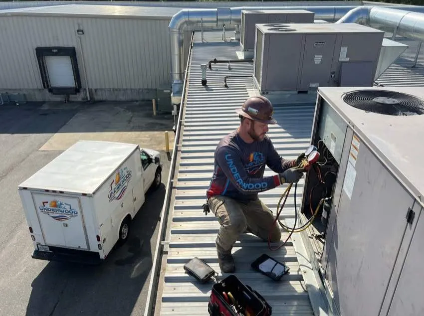 HVAC technician working on rooftop unit